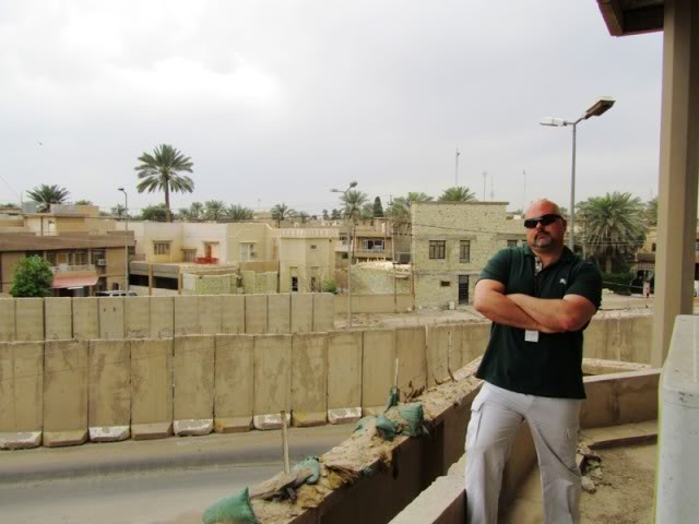 Kevin in front of tan buildings