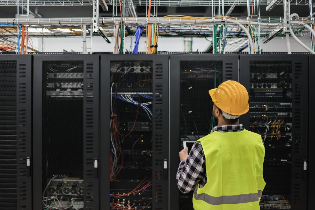 Project Manager working with tablet inside big data center